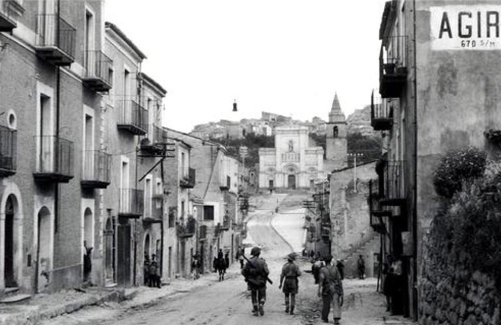 A historical image of a town in Italy.