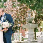 A bride and groom pose for an outdoor photo at the Columbus Centre courtyard.