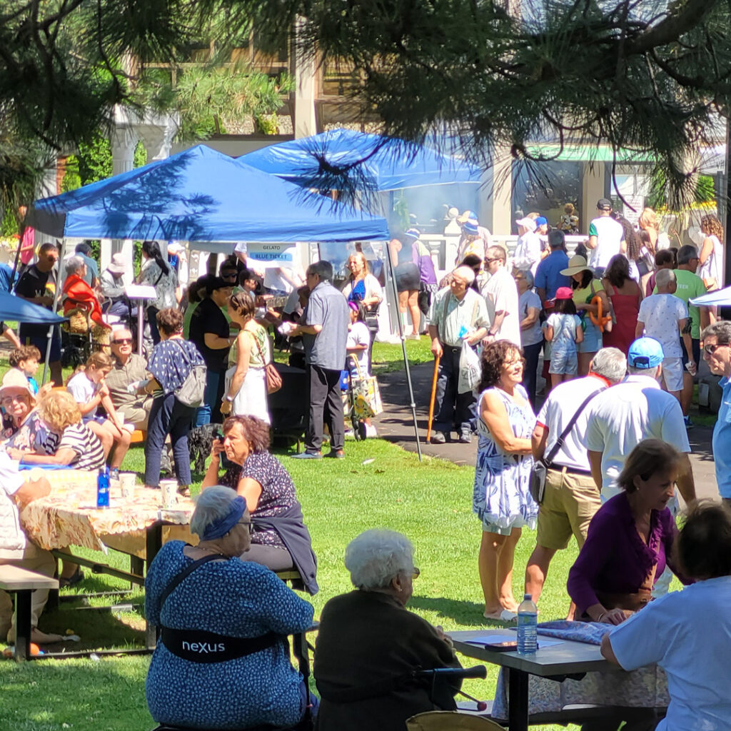 Tents and people seen enjoying at courtyard of Villa Charities