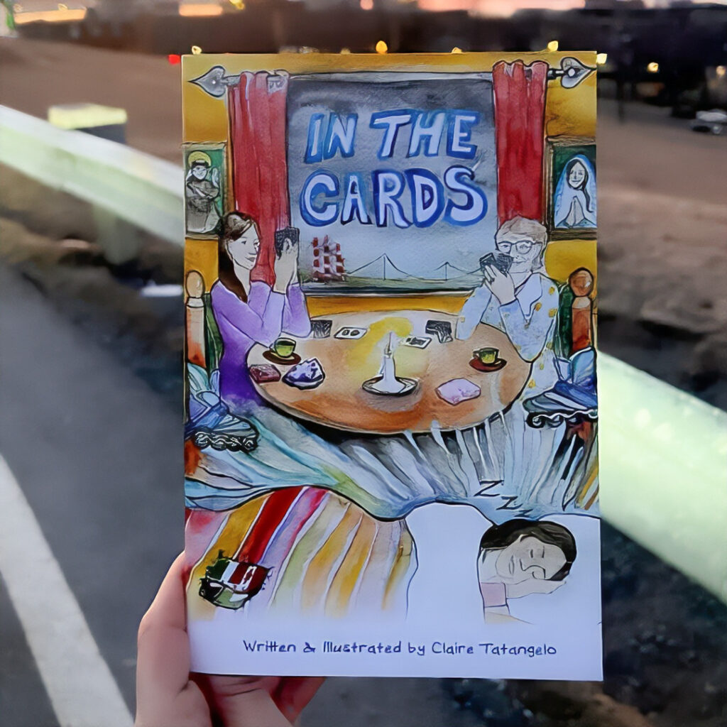 Book "In the cards" seen held in hand on a street