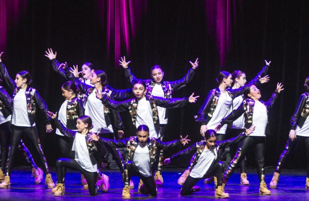 A group of competitive DanzArts Toronto dancers pose during a dance performance.